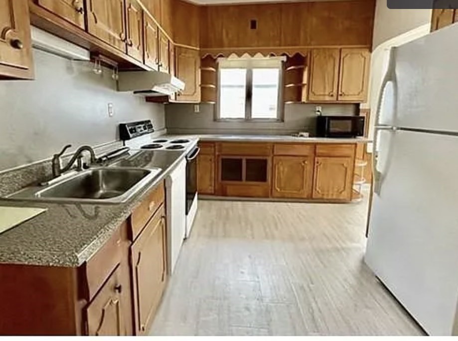 24 Somerset Street, Unit 2 Worcester, MA 01609 - Photo 2 of 16 a kitchen with stainless steel appliances granite countertop a sink and a refrigerator
