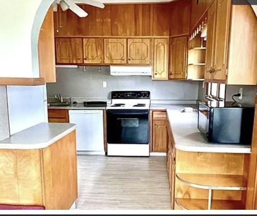 24 Somerset Street, Unit 2 Worcester, MA 01609 - Photo 4 of 16 a kitchen with stainless steel appliances granite countertop a stove a sink and a microwave