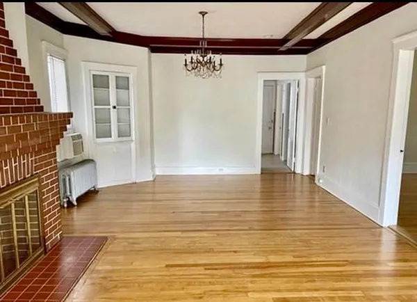 a view of a livingroom with wooden floor and a ceiling fan