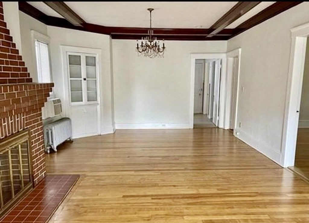 24 Somerset Street, Unit 2 Worcester, MA 01609 - Photo 6 of 16 a view of a livingroom with wooden floor and a ceiling fan