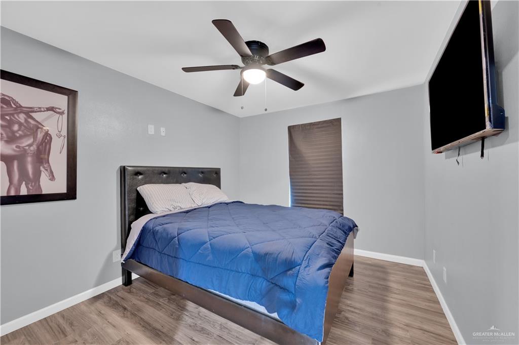 405 East Guerra Street Rio Grande City, TX 78582 - Photo 10 of 33 Bedroom featuring wood finished floors, baseboards, and ceiling fan