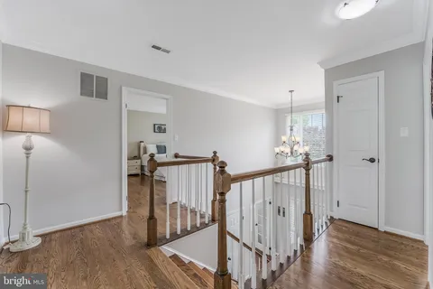 a view of a bedroom with a bed and a chandelier fan