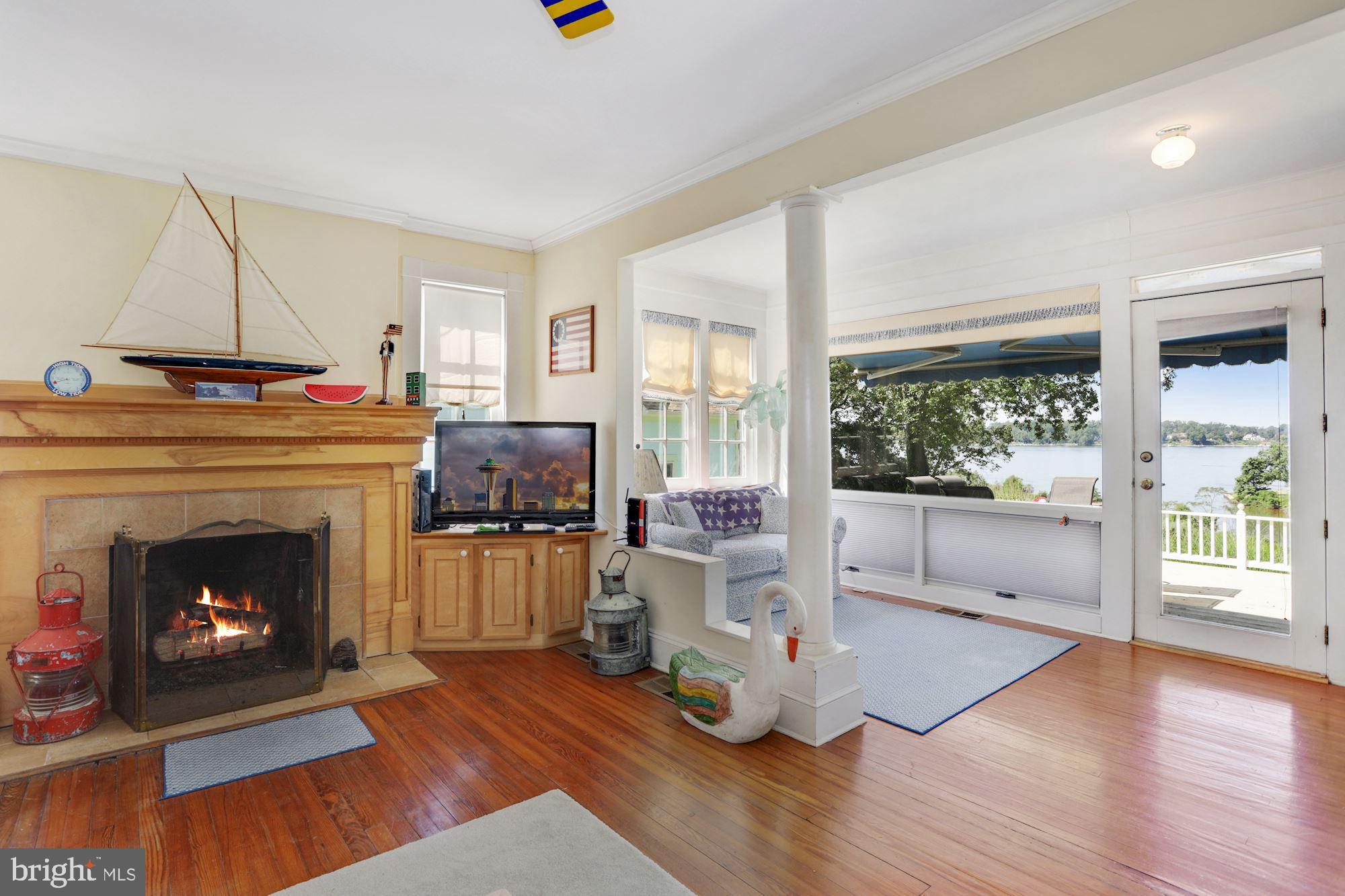10 West Severn Ridge Road Annapolis, MD 21409 - Photo 15 of 31 Living room features a FP and gorgeous water views