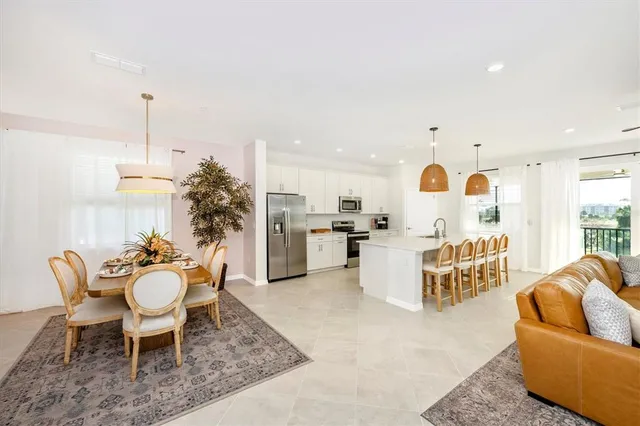 a dining room with furniture a rug and wooden floor