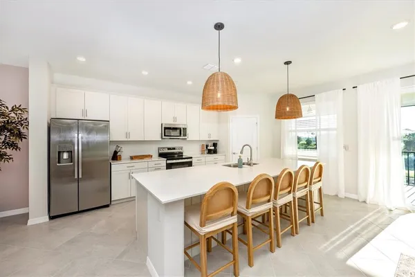 a spacious bedroom with a bed and flat screen tv