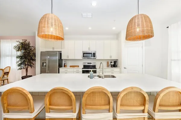 a spacious bedroom with a bed and a potted plant