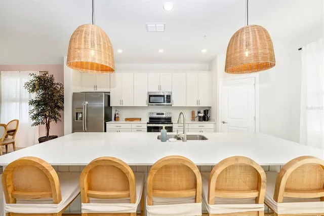 a spacious bedroom with a bed and a potted plant