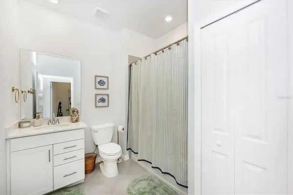 a front view of a house with glass windows and furniture