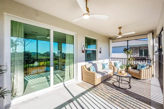 a swimming pool view with a seating space and a garden view