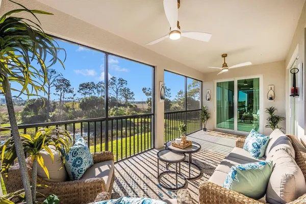 a view of a house with backyard porch and sitting area