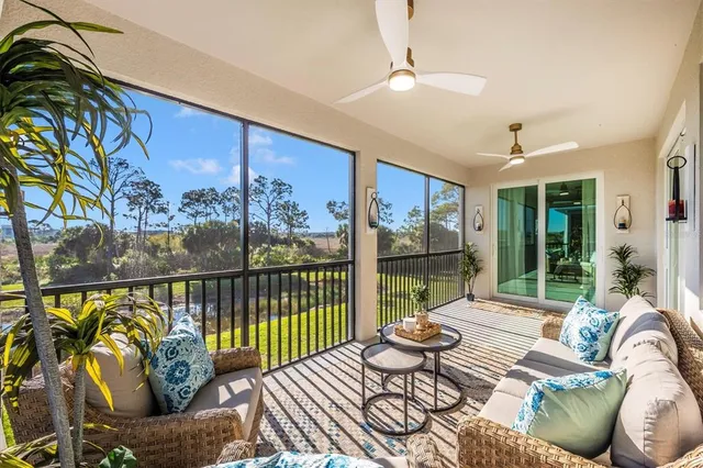 a front view of a house with glass windows and furniture