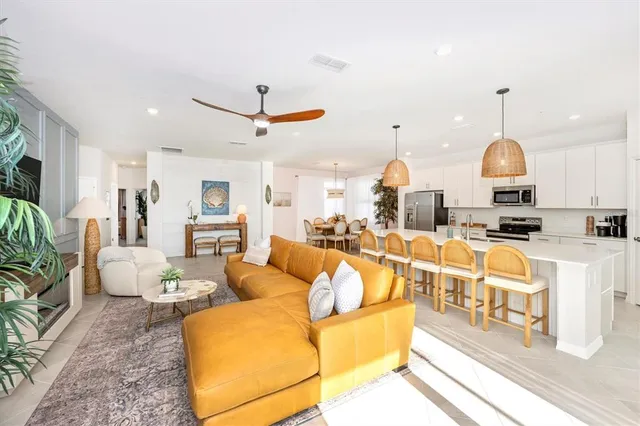 a dining room with furniture and a potted plant