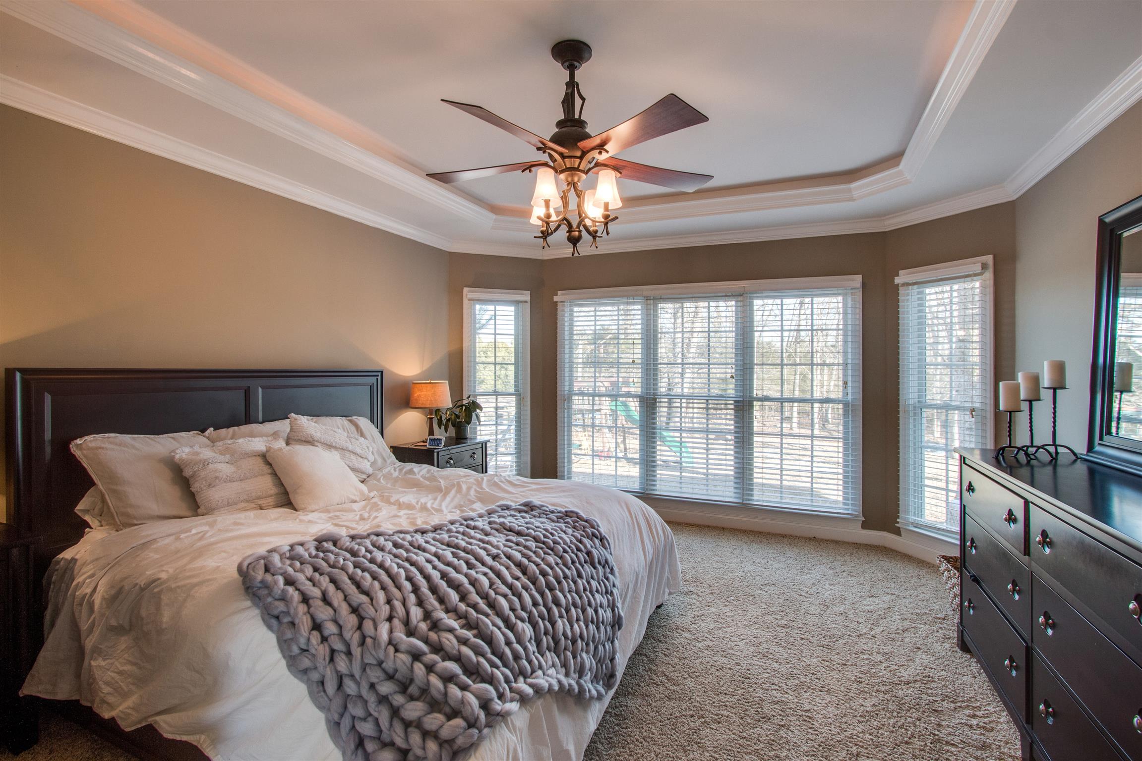 210 Ridgewater Way Mount Juliet, TN 37122 - Photo 10 of 24 a bedroom with a large bed and a chandelier