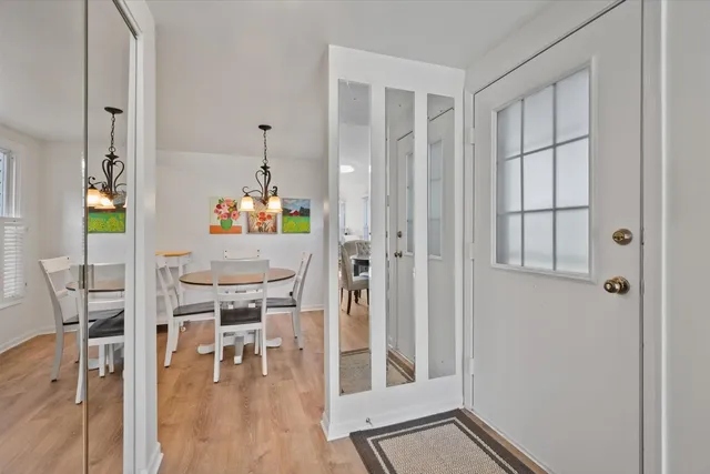 a view of dining room with wooden floor and furniture