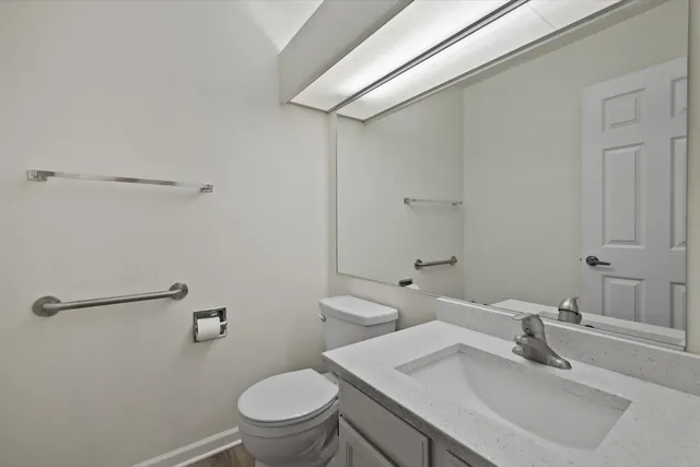 a bathroom with a sink toilet and vanity