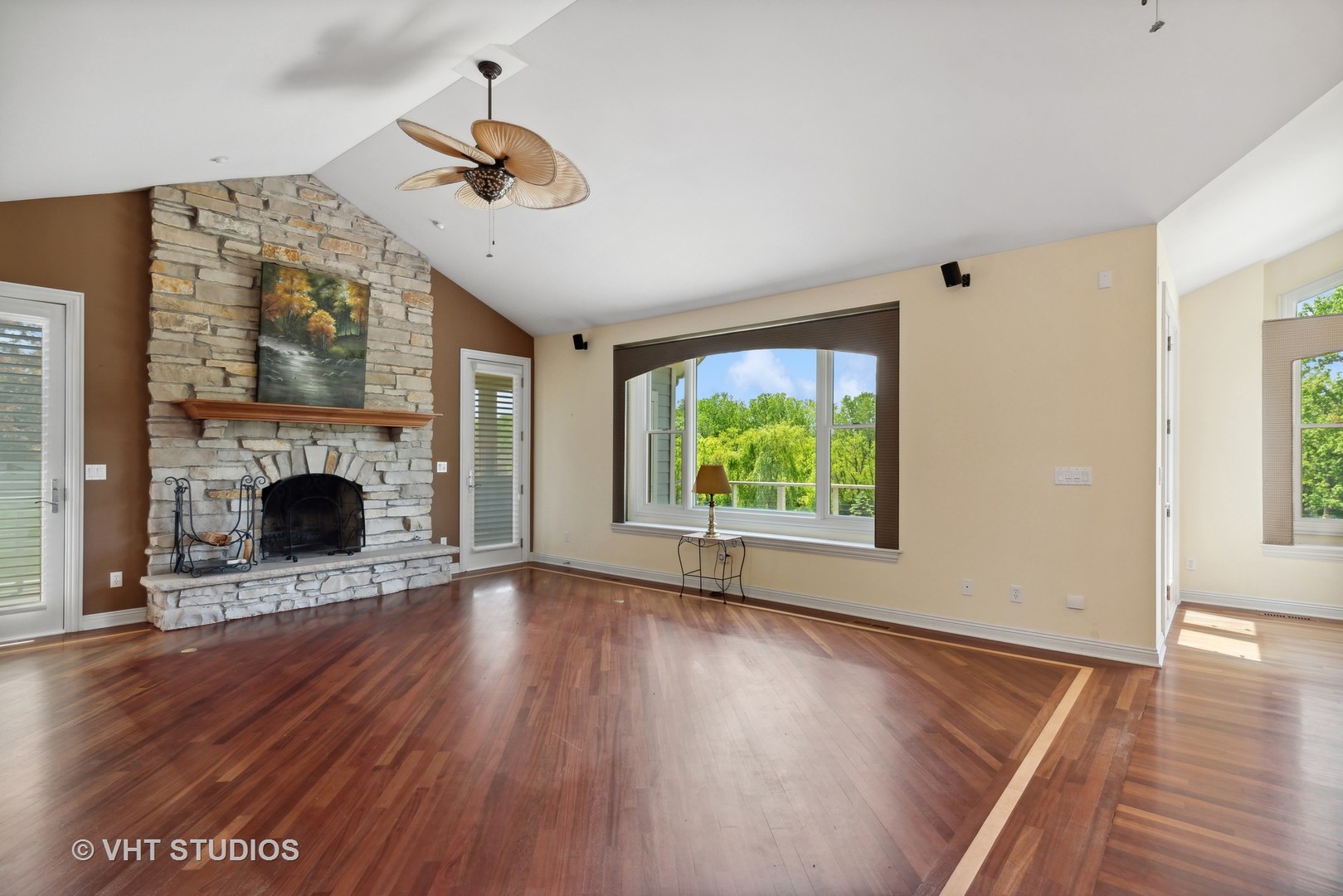 10701 Knickerbocker Road Harvard, IL 60033 - Photo 12 of 46 a view of an empty room with wooden floor a fireplace and a window
