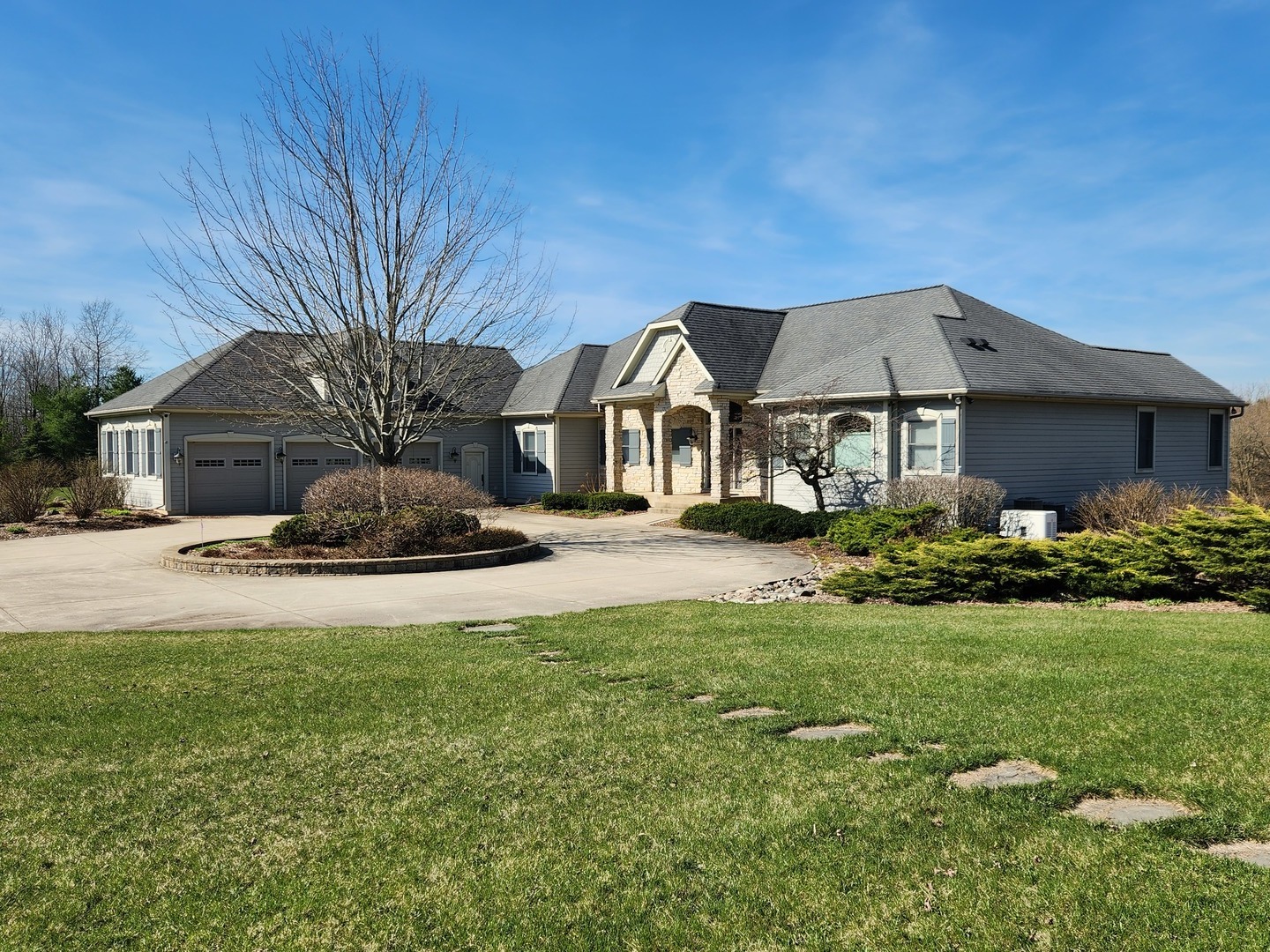 10701 Knickerbocker Road Harvard, IL 60033 - Photo 2 of 46 a front view of a house with garden