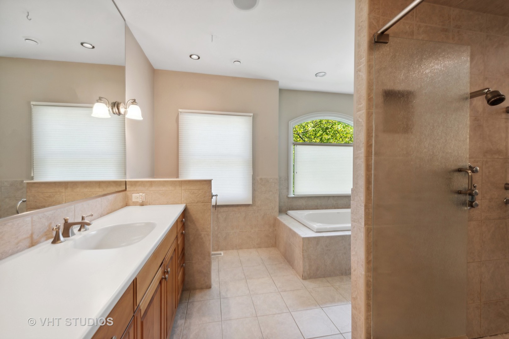 10701 Knickerbocker Road Harvard, IL 60033 - Photo 23 of 46 a bathroom with a granite countertop sink a toilet a mirror and bathtub