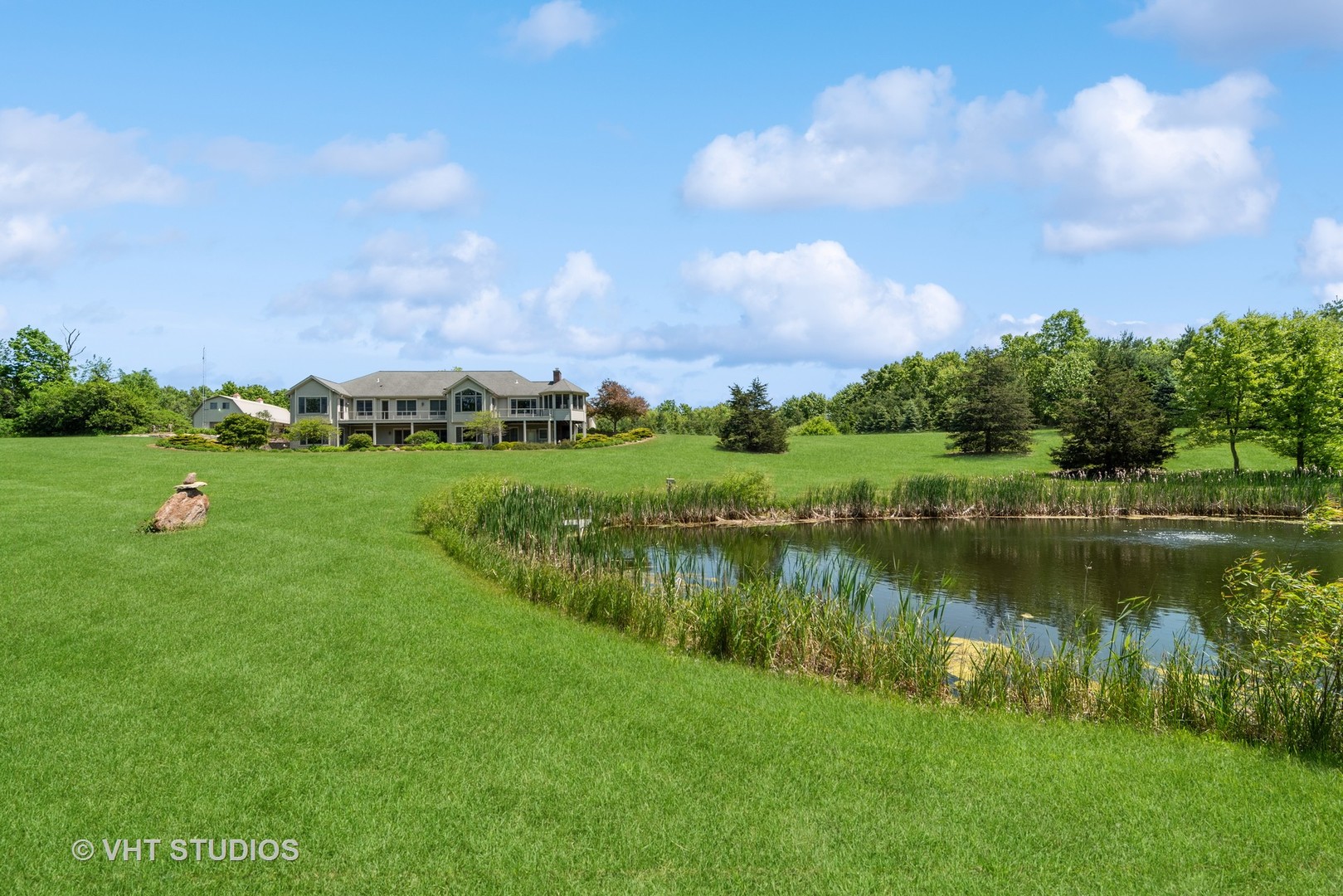10701 Knickerbocker Road Harvard, IL 60033 - Photo 4 of 46 a view of a lake with a big yard