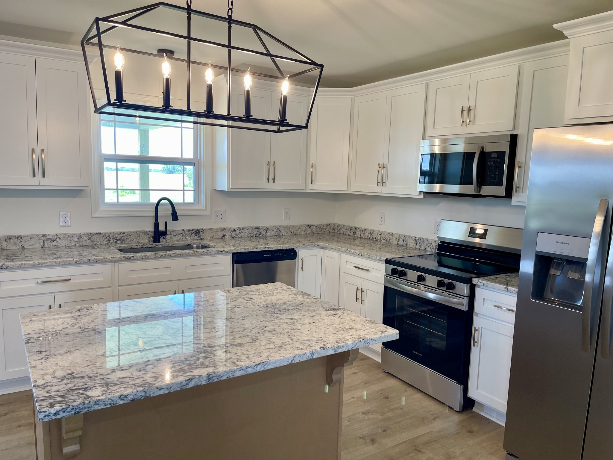 104 Donald Road Lafayette, TN 37083 - Photo 8 of 22 a kitchen with stainless steel appliances granite countertop a sink stove and microwave