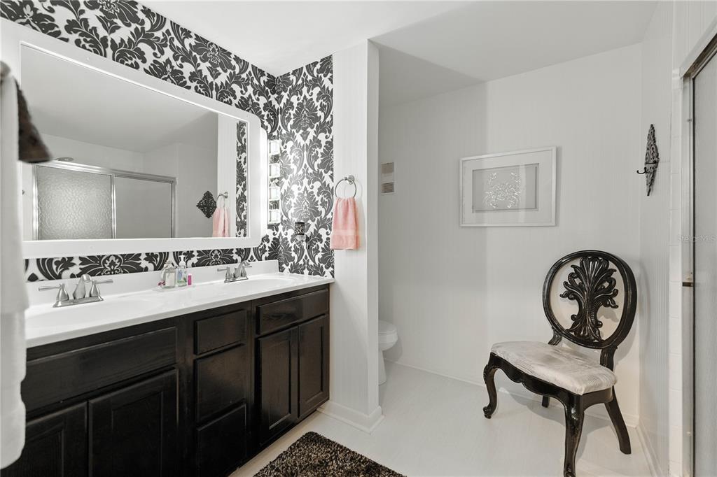 9951 Southwest 88th Court Road, Unit B Ocala, FL 34481 - Photo 18 of 29 a bathroom with a sink mirror and vanity