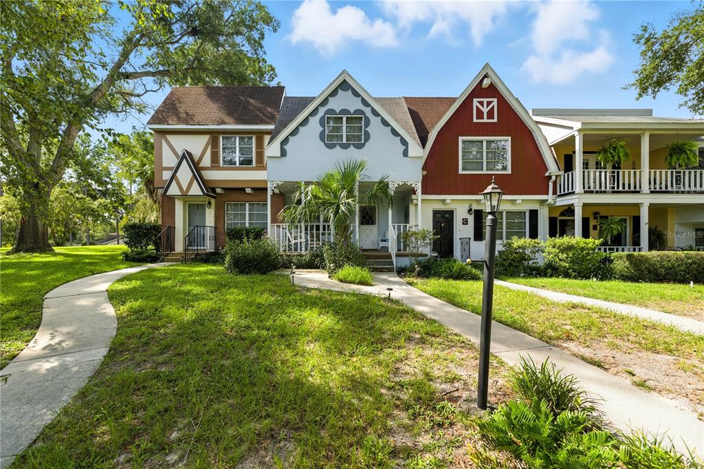 9951 Southwest 88th Court Road, Unit B Ocala, FL 34481 - Photo 2 of 29 a front view of a house with a yard and potted plants
