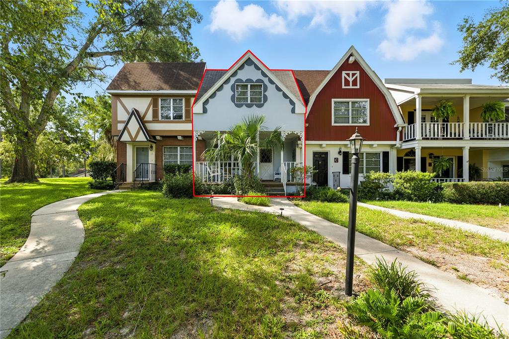 9951 Southwest 88th Court Road, Unit B Ocala, FL 34481 - Photo 4 of 29 a front view of a house with a yard and porch