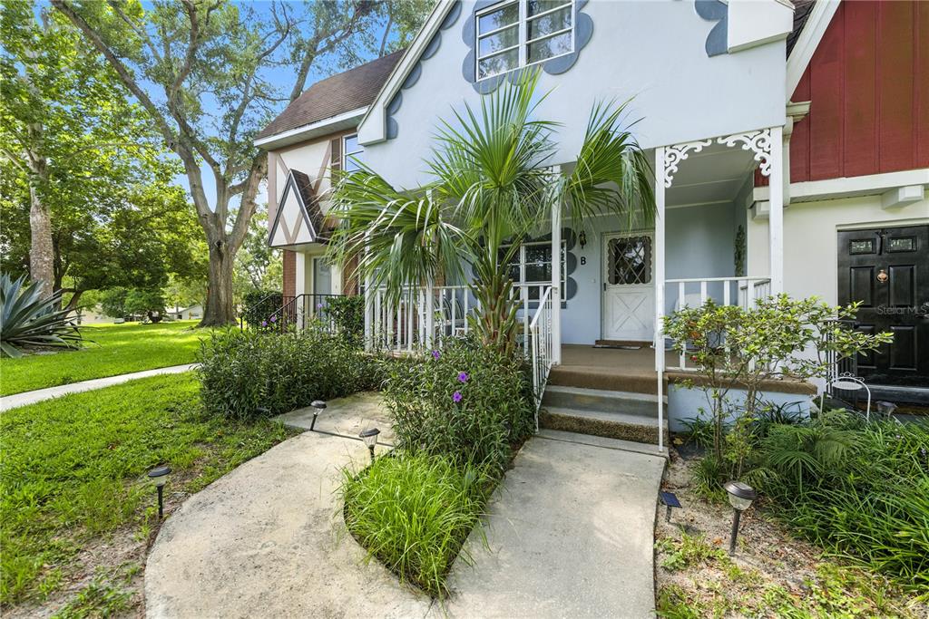 9951 Southwest 88th Court Road, Unit B Ocala, FL 34481 - Photo 5 of 29 a front view of a house with a yard