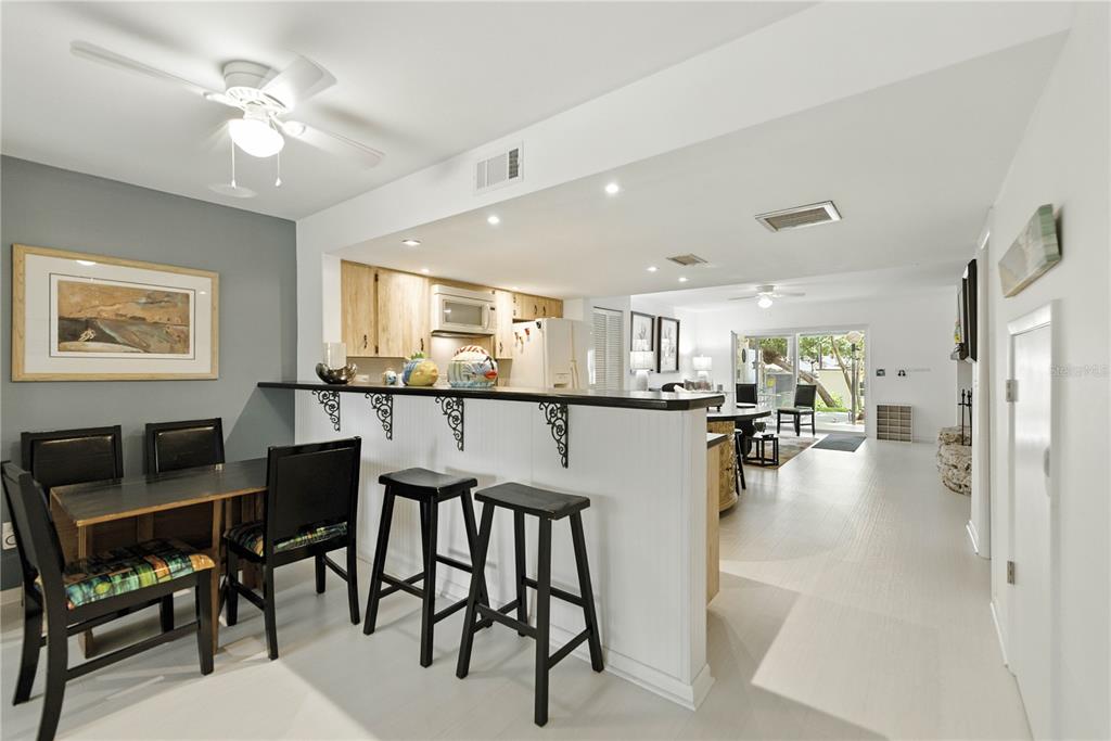 9951 Southwest 88th Court Road, Unit B Ocala, FL 34481 - Photo 8 of 29 a view of a dining room kitchen with furniture and a large window