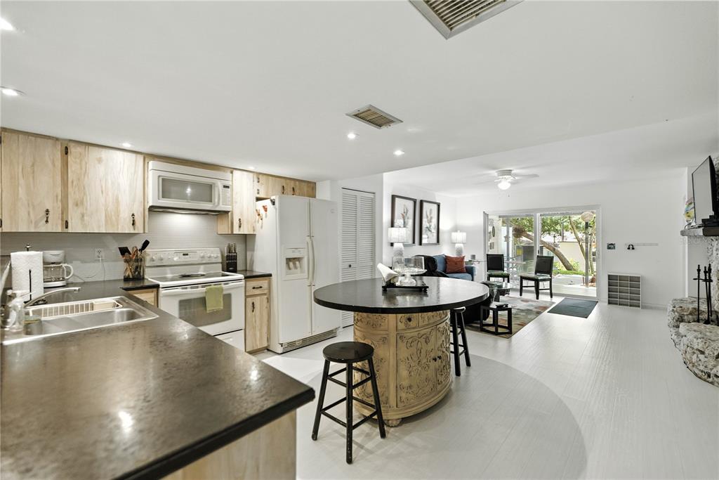 9951 Southwest 88th Court Road, Unit B Ocala, FL 34481 - Photo 9 of 29 a kitchen with sink stove and cabinets