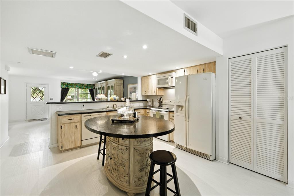 9951 Southwest 88th Court Road, Unit B Ocala, FL 34481 - Photo 10 of 29 a dining room with table chairs and kitchen view