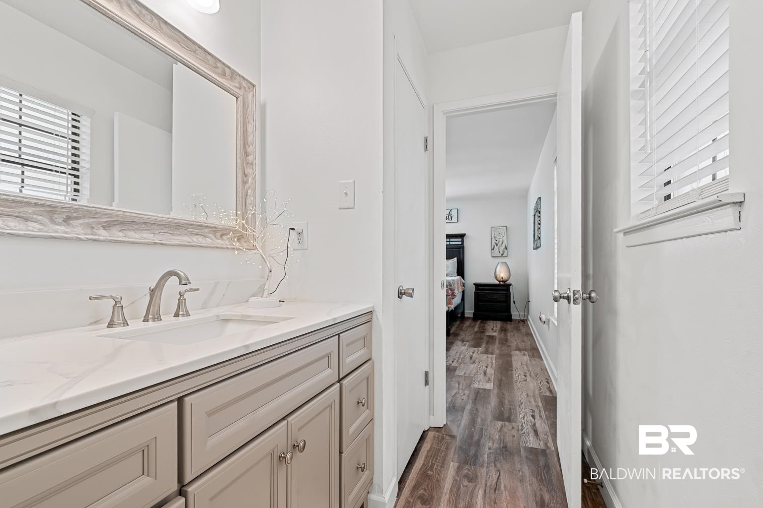 6801 Piney Woods Road Foley, AL 36535 - Photo 46 of 74 Bathroom featuring plenty of natural light, vanity, and dark wood-type flooring