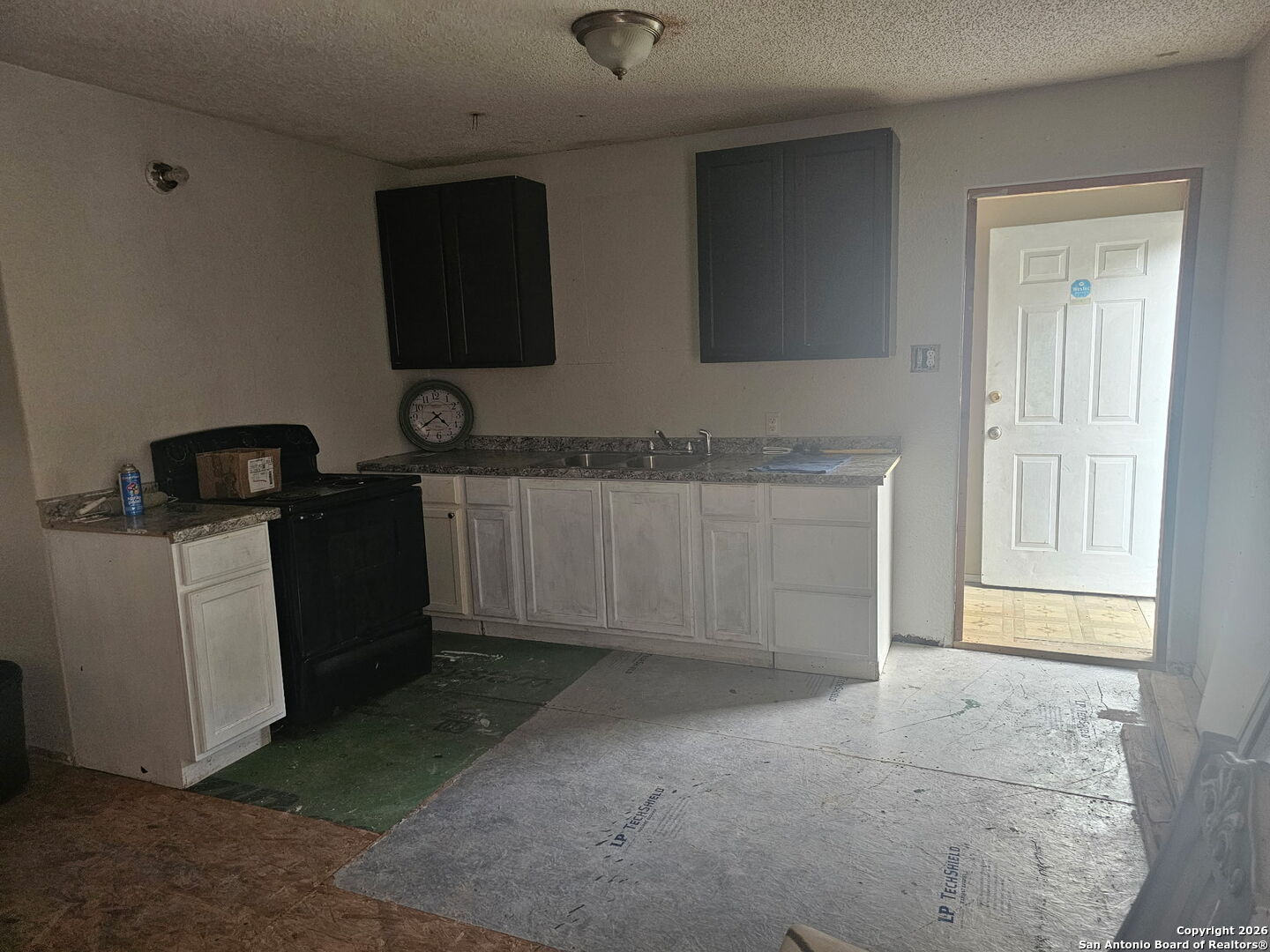 907 Hough Adkins, TX 78101 - Photo 4 of 10 a kitchen with a sink and cabinets