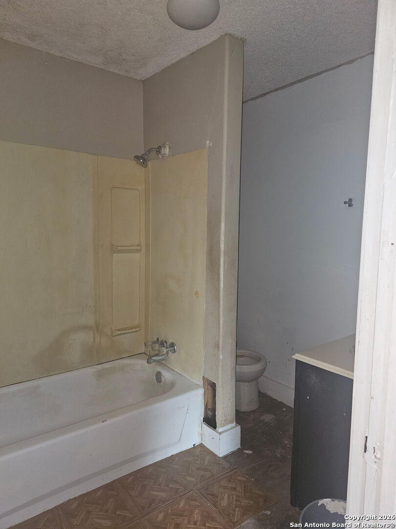 907 Hough Adkins, TX 78101 - Photo 7 of 10 a bathroom with a granite countertop bathtub shower and toilet