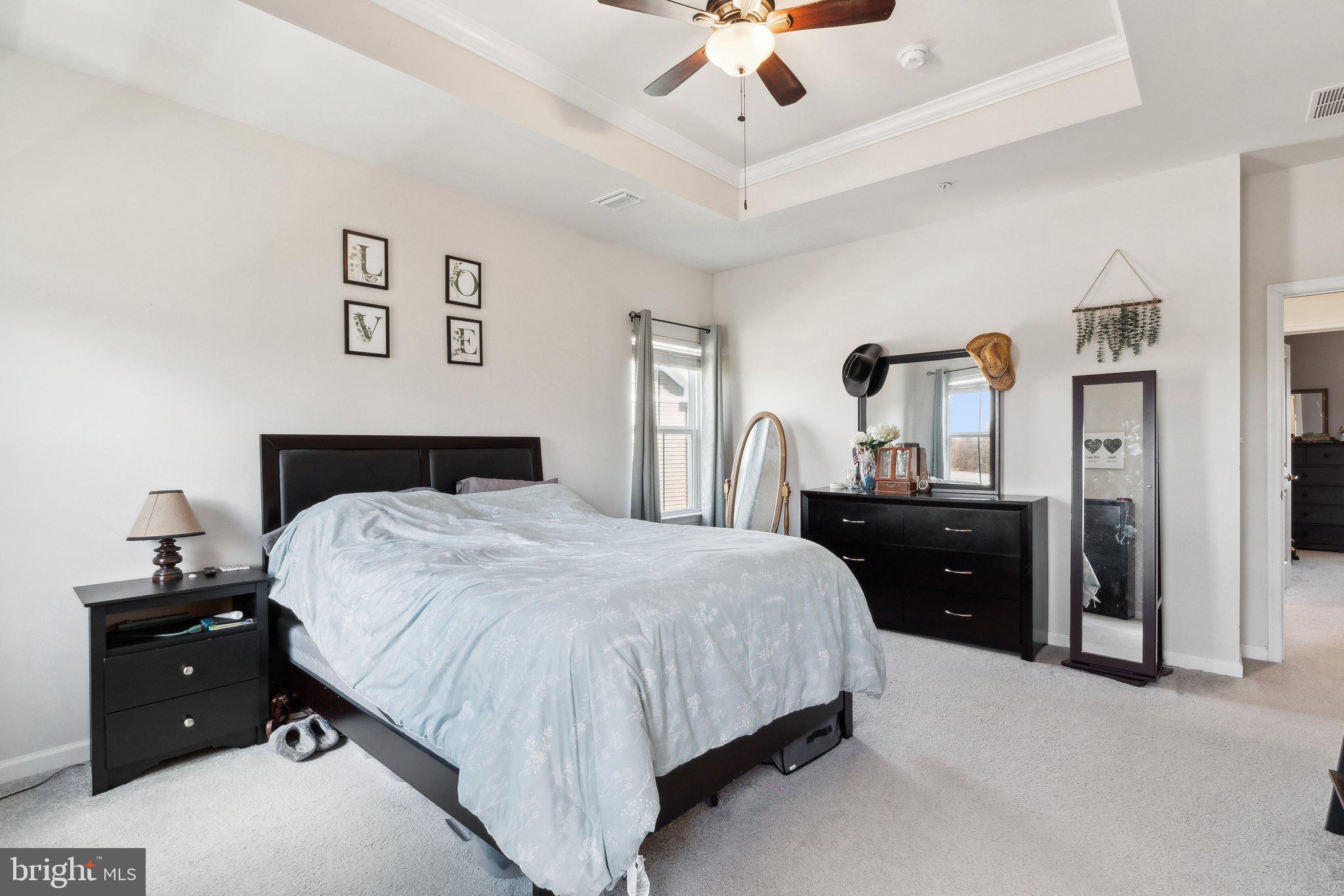 3012 Shaws Road Edgemere, MD 21219 - Photo 15 of 57 a bedroom with a bed and a chandelier
