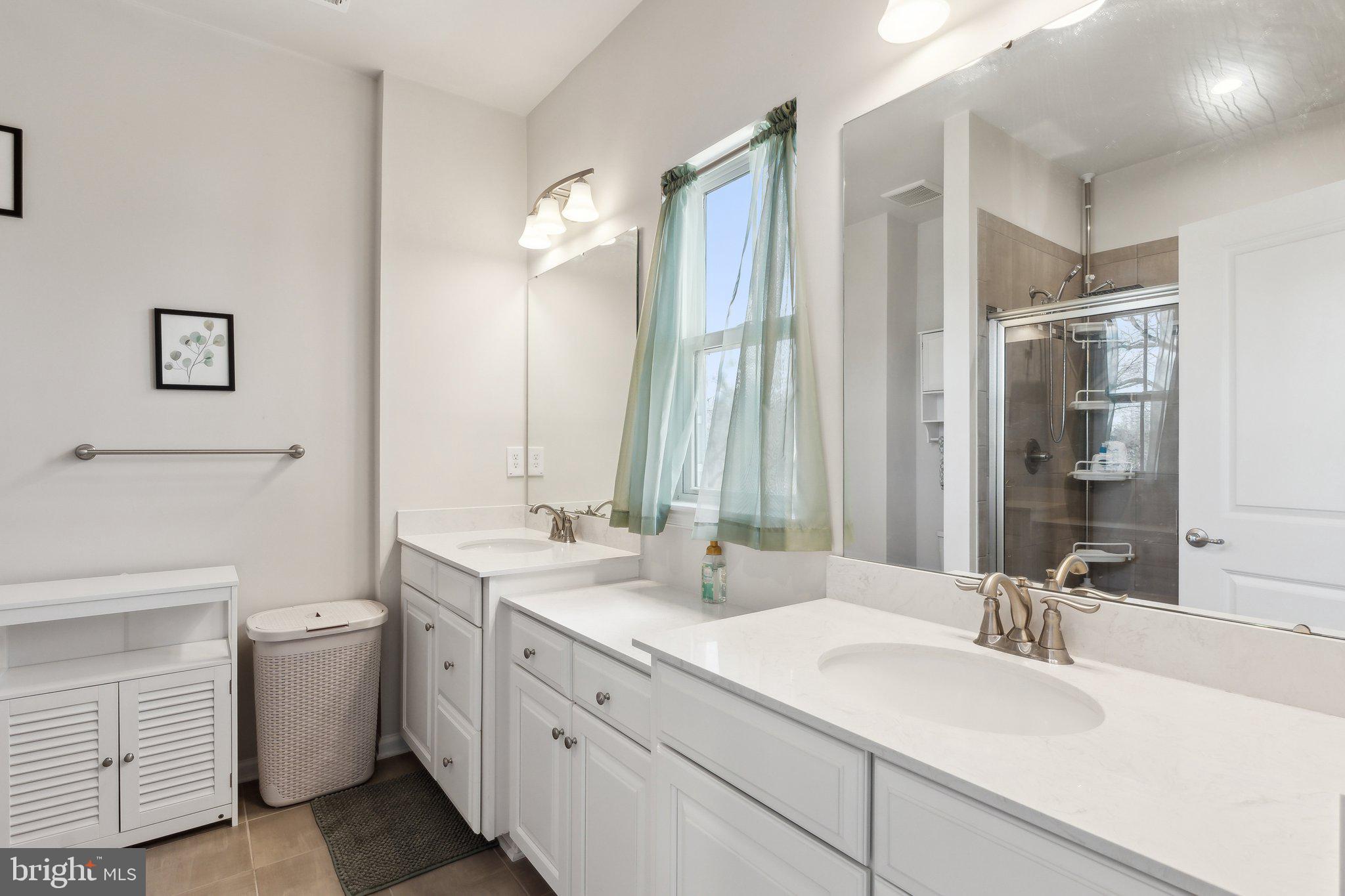 3012 Shaws Road Edgemere, MD 21219 - Photo 17 of 57 a bathroom with a double vanity sink mirror and toilet