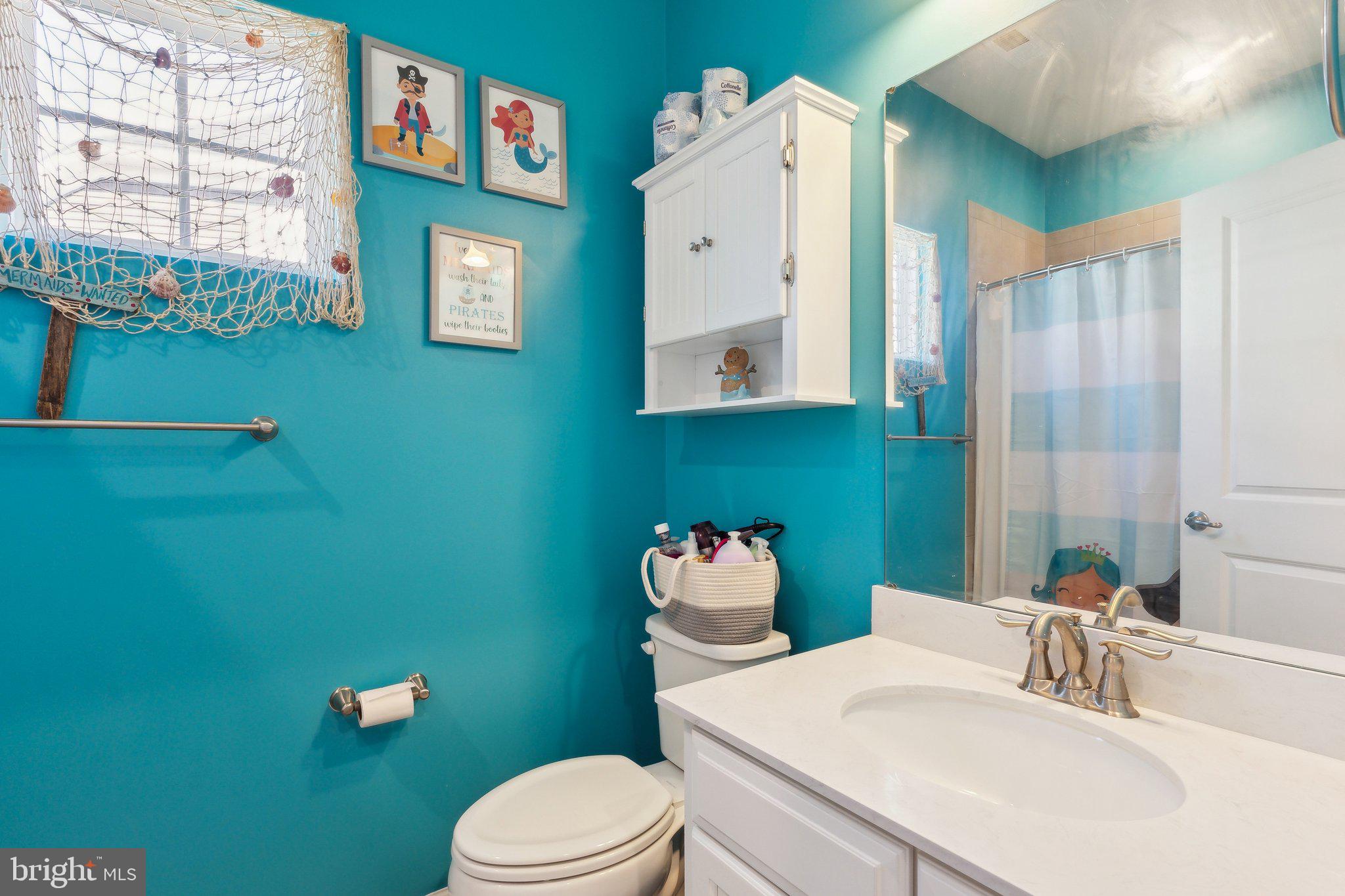 3012 Shaws Road Edgemere, MD 21219 - Photo 25 of 57 a bathroom with a sink mirror and toilet
