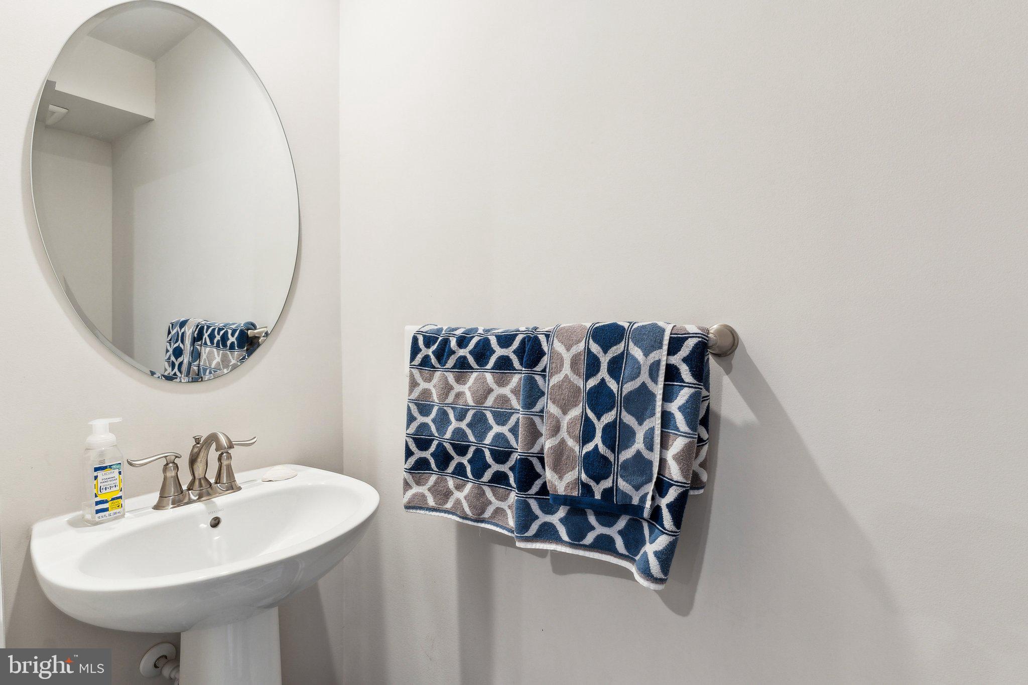 3012 Shaws Road Edgemere, MD 21219 - Photo 29 of 57 a bathroom with a sink and mirror