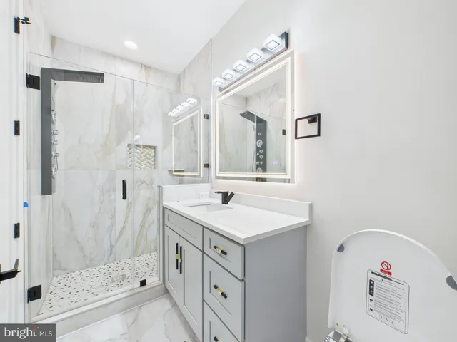 a bathroom with a sink toilet and shower