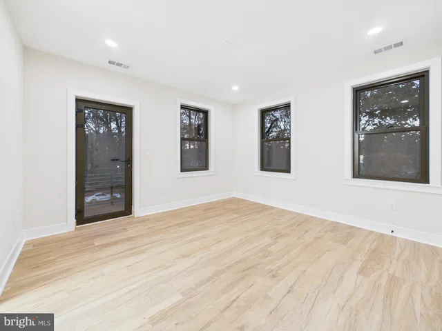 an empty room with windows and closet
