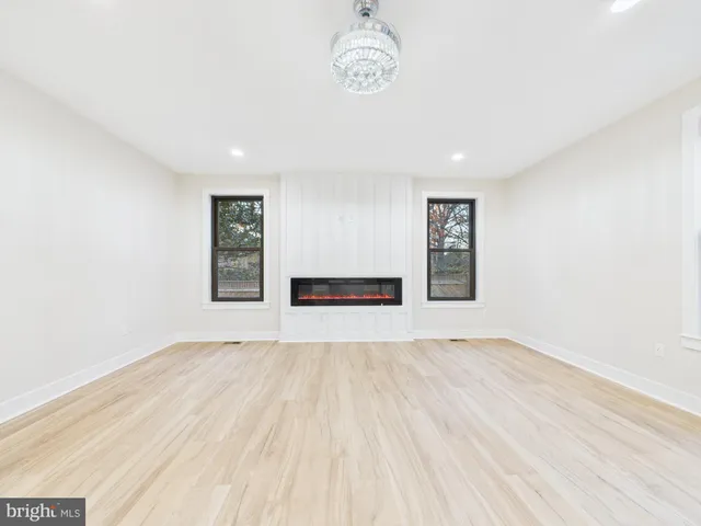 a front view of a house with a garden and lake view