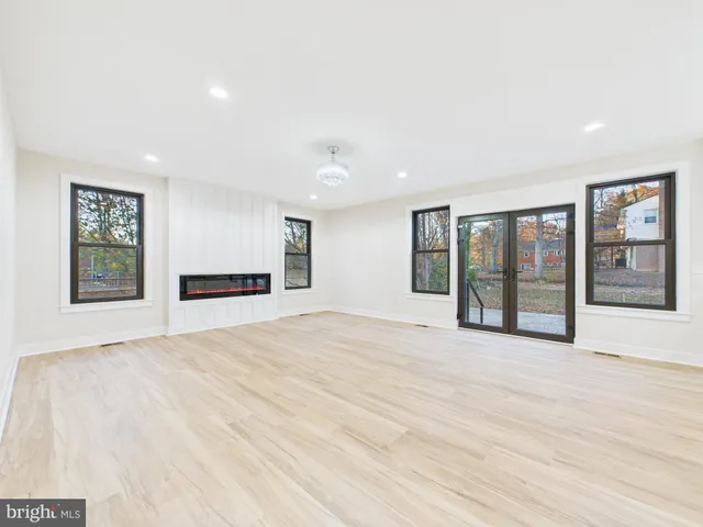 a view of a house with a big yard and large trees
