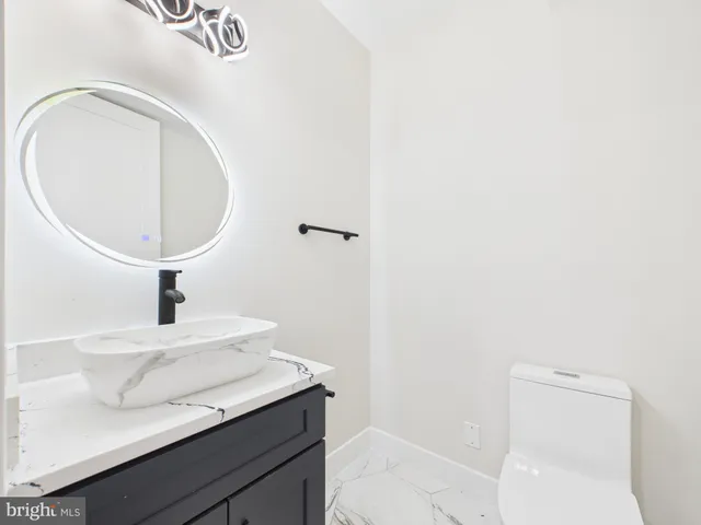 a view of a kitchen with large windows and a living room