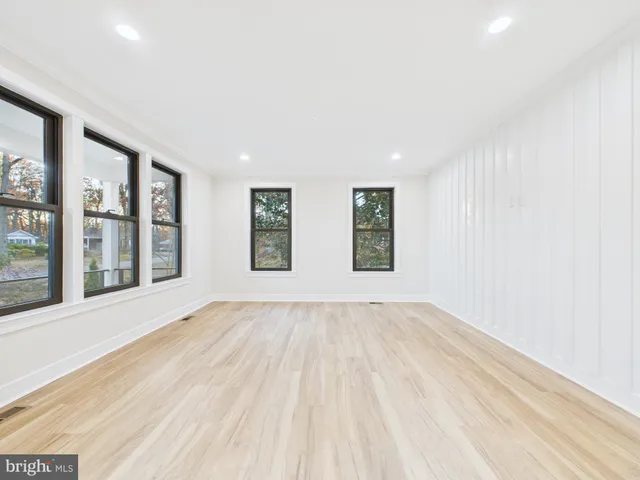 a spacious bathroom with a bathtub shower sink mirror and toilet