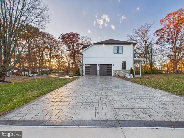 a view of a house with a yard and pathway