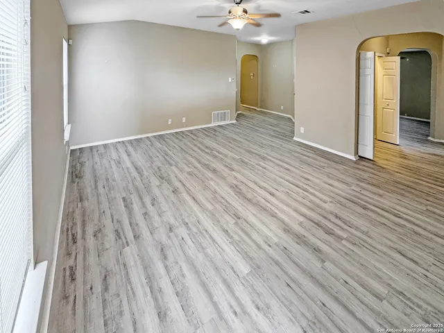 wooden floor in an empty room with a mirror