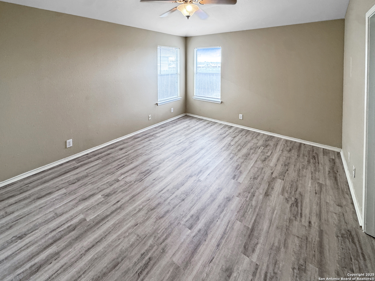 312 Hummingbird Drive New Braunfels, TX 78130 - Photo 14 of 20 wooden floor in an empty room with a window