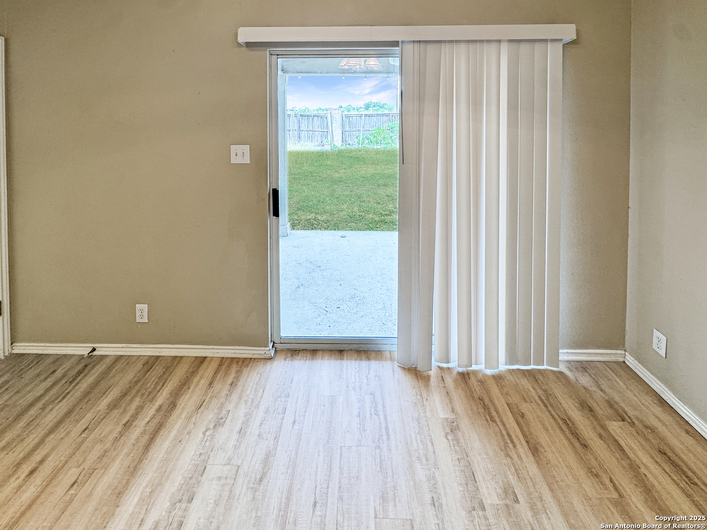 312 Hummingbird Drive New Braunfels, TX 78130 - Photo 18 of 20 a view of a room with wooden floor and a window