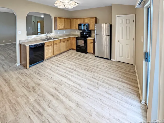 a kitchen with stainless steel appliances granite countertop a refrigerator and a sink