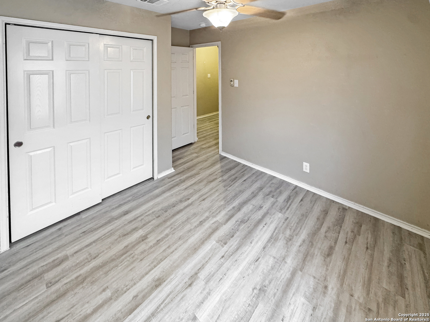 312 Hummingbird Drive New Braunfels, TX 78130 - Photo 10 of 20 a view of an empty room with wooden floor